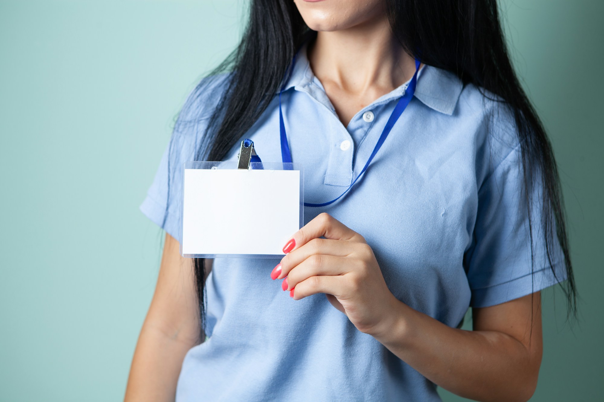 Person holding a student ID badge